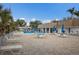 Community pool with lounge chairs and tables offers a relaxing outdoor space at 5571 Riverbluff Cir # V1, Sarasota, FL 34231