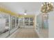 Bright sunroom features carpeted floors, large windows with lots of natural light, and ceiling fan at 5571 Riverbluff Cir # V1, Sarasota, FL 34231