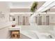 Bathroom with a large mirror, corner bathtub, vanity area, and coordinated decor for a serene experience at 5608 Country Club Way # 5608, Sarasota, FL 34243