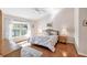 Bright bedroom featuring a cozy bed, wood floors and a picturesque window view for a peaceful retreat at 5608 Country Club Way # 5608, Sarasota, FL 34243