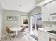 Eat-in kitchen area with a breakfast table and sliding glass doors to the patio at 5608 Country Club Way # 5608, Sarasota, FL 34243