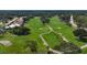 Aerial view of golf course pathways winding through lush green fairways and mature trees in a serene community setting at 5608 Country Club Way # 5608, Sarasota, FL 34243