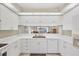 Bright kitchen featuring white cabinetry, countertop, and stainless steel appliances at 5608 Country Club Way # 5608, Sarasota, FL 34243