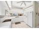 Clean kitchen featuring white appliances, tiled floor, and ample counter space at 5608 Country Club Way # 5608, Sarasota, FL 34243