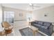 Cozy living room with patterned wallpaper, tile floors, and a comfortable striped sofa at 5608 Country Club Way # 5608, Sarasota, FL 34243