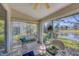 Bright sunroom with a view of a pond and beautiful trees at 5608 Country Club Way # 5608, Sarasota, FL 34243
