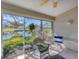 Bright sunroom with tiled floor and large windows overlooking beautiful pond views at 5608 Country Club Way # 5608, Sarasota, FL 34243