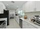 Bright kitchen with white cabinets and stainless steel appliances at 5901 La Vista Ln, Bradenton, FL 34210