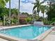 Community pool with clear blue water, surrounded by green trees at 5901 La Vista Ln, Bradenton, FL 34210