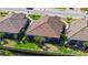 Aerial view of a home with a screened in lanai, well maintained landscaping, and a tile roof at 6070 Mesa Gln, Bradenton, FL 34203