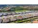 Community aerial view of a neighborhood with tile roofs, a lake and lush landscapes at 6070 Mesa Gln, Bradenton, FL 34203