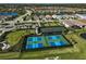 Aerial view of the community with pickleball, tennis courts, lakes, and beautiful homes at 6070 Mesa Gln, Bradenton, FL 34203