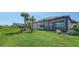 Manicured backyard showcasing verdant lawn, privacy wall and a screened in lanai at 6070 Mesa Gln, Bradenton, FL 34203
