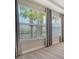 Bedroom windows with views of palm trees and neutral colored walls at 6070 Mesa Gln, Bradenton, FL 34203