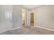 Comfortable bedroom with multiple doorways leading to an ensuite bathroom and carpeted floors at 6070 Mesa Gln, Bradenton, FL 34203