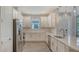 Well-lit kitchen featuring stainless appliances, shaker cabinets, and quartz countertops at 6070 Mesa Gln, Bradenton, FL 34203