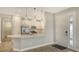 Modern kitchen features stainless steel appliances, white cabinetry, and a breakfast bar at 6070 Mesa Gln, Bradenton, FL 34203