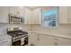 Close up of kitchen with stainless appliances, quartz countertops, and subway backsplash at 6070 Mesa Gln, Bradenton, FL 34203