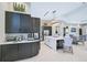 Spacious kitchen features an island, modern appliances, dark cabinets, and white countertops at 6070 Mesa Gln, Bradenton, FL 34203