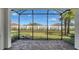 Screened lanai offers views of the backyard and white privacy wall at 6070 Mesa Gln, Bradenton, FL 34203