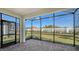 Screened lanai offers views of the backyard and white privacy wall at 6070 Mesa Gln, Bradenton, FL 34203