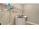 Modern laundry room with gray tile and front load washer and dryer hook-ups at 6070 Mesa Gln, Bradenton, FL 34203