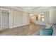 Open-concept living space with wood-style tile flooring and seamless flow to kitchen at 6070 Mesa Gln, Bradenton, FL 34203