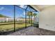 Enclosed patio with brick floor, overlooks manicured lawn and privacy fence at 6070 Mesa Gln, Bradenton, FL 34203
