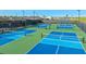 Outdoor pickleball courts with green and blue playing surfaces, enclosed by a black fence, provide a fun recreational space at 6070 Mesa Gln, Bradenton, FL 34203
