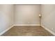 Neutral room featuring light walls, wood-look tile flooring, and white trim at 6070 Mesa Gln, Bradenton, FL 34203