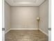 Neutral room featuring light walls, wood-look tile flooring, and white trim at 6070 Mesa Gln, Bradenton, FL 34203