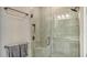 Modern tiled shower with glass door, rainfall shower head, and corner seat at 6070 Mesa Gln, Bradenton, FL 34203