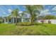 Backyard view showing house, screened porch, palm trees and fencing at 6433 Blue Grosbeak Cir, Lakewood Ranch, FL 34202