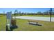 Community basketball court with multiple hoops, benches, and nearby signage, perfect for sports and recreation at 6433 Blue Grosbeak Cir, Lakewood Ranch, FL 34202