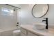 Stylish bathroom featuring a modern sink bowl, round mirror and tiled shower at 6433 Blue Grosbeak Cir, Lakewood Ranch, FL 34202