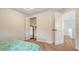 Bedroom with modern floors, closet, and door to adjacent room at 6433 Blue Grosbeak Cir, Lakewood Ranch, FL 34202