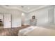Bedroom featuring an vintage dresser, wood floors, and neutral decor at 6433 Blue Grosbeak Cir, Lakewood Ranch, FL 34202