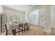 Dining room with arch window, stylish furniture and floors, plus access to the front door at 6433 Blue Grosbeak Cir, Lakewood Ranch, FL 34202