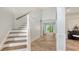 Welcoming foyer with staircase, white wainscoting and entry to the living space at 6433 Blue Grosbeak Cir, Lakewood Ranch, FL 34202