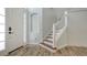 Inviting entryway with wood-look tile flooring, a staircase, and decorative molding at 6433 Blue Grosbeak Cir, Lakewood Ranch, FL 34202