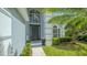 Stunning home entry featuring a grand two-story foyer with transom windows and mature landscaping at 6433 Blue Grosbeak Cir, Lakewood Ranch, FL 34202