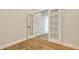 Hallway with wood floors and French doors leading to another room at 6433 Blue Grosbeak Cir, Lakewood Ranch, FL 34202