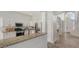 Bright kitchen boasts granite countertops, stainless steel appliances, and white cabinets at 6433 Blue Grosbeak Cir, Lakewood Ranch, FL 34202