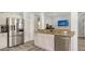 Spacious kitchen with stainless steel appliances and granite countertops adjacent to living area at 6433 Blue Grosbeak Cir, Lakewood Ranch, FL 34202