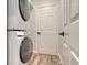 Convenient laundry room featuring a stacked washer and dryer at 6433 Blue Grosbeak Cir, Lakewood Ranch, FL 34202