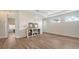 Open-concept living room boasts modern floors, a shiplap accent wall, and natural light from multiple windows at 6433 Blue Grosbeak Cir, Lakewood Ranch, FL 34202