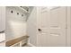 A stylish mud room features a built-in bench with storage and coat hooks for organization at 6433 Blue Grosbeak Cir, Lakewood Ranch, FL 34202