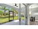 Screened patio with ceiling fan offers views of the lush backyard and dining area at 6433 Blue Grosbeak Cir, Lakewood Ranch, FL 34202