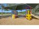 Community playground featuring a covered play structure with slides, climbing areas, and various play features for children at 6433 Blue Grosbeak Cir, Lakewood Ranch, FL 34202