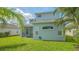 View of the back of the house and a well maintained lawn with palm trees at 6433 Blue Grosbeak Cir, Lakewood Ranch, FL 34202